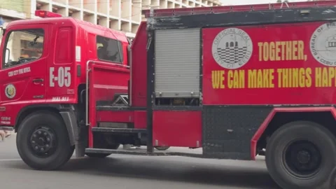 A Fire Engine traveling along an urban road in Cebu City Stock Footage 285999751