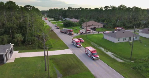 Fire engine trucks and ambulance vehicles responding to fire alarm Stock Footage 318469098