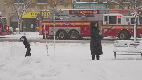 Fire engines are dispatched on 2nd Avenue during snowstorm hits in East Village Stock Footage 337369644