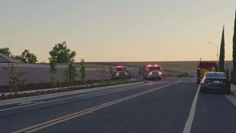 Fire engines respond to an emergency on residential street Stock Footage 340292823