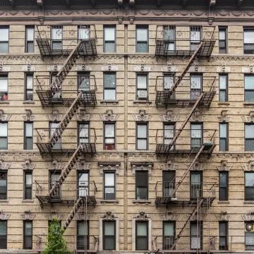 A fire escape of an apartment building in New York city Stock Photos