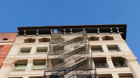 Fire Escape Attached to a Historic Multi Story Apartment Building Exterior 库存影片 330985909