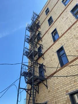 Fire escape on the wall of the house Stock Photos