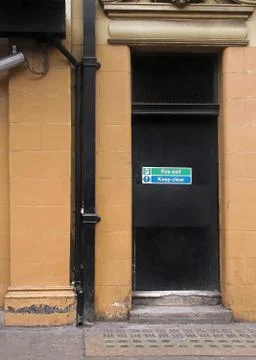 Fire exit door exterior with warning signs to keep clear Stock Photos