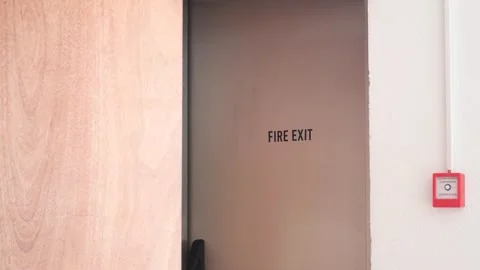 Fire exit door in office building with emergency alarm and safety signs in .. Stock Footage 332880053