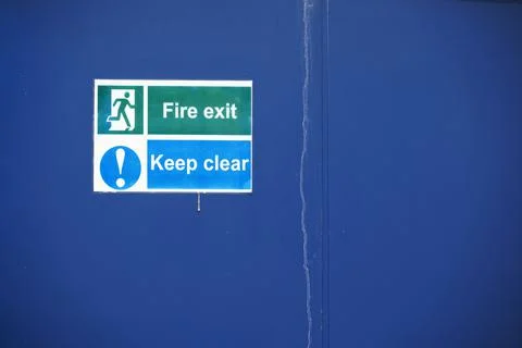 Fire exit keep clear sign on construction building site door Stock Photos