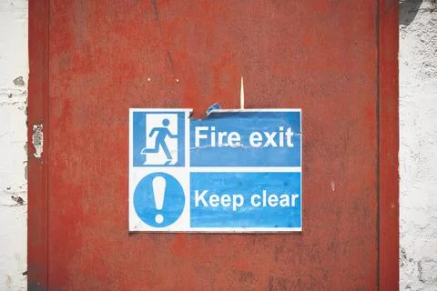 Fire exit keep clear sign on construction building site door Stock Photos
