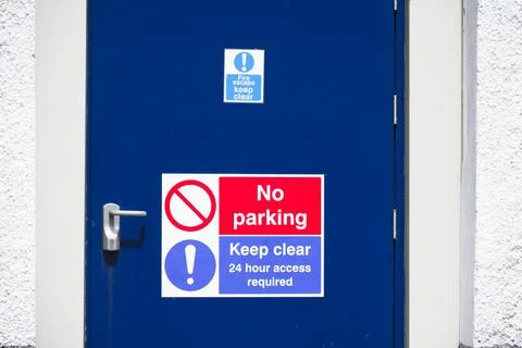 Fire exit keep clear sign on construction building site door Stock Photos