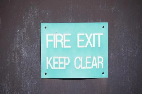Fire exit keep clear sign on construction building site door Stock Photos