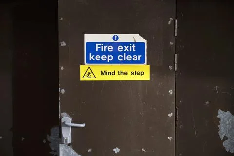 Fire exit keep clear sign on construction building site door Stock Photos