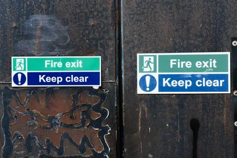 Fire exit keep clear sign on construction building site door Stock Photos