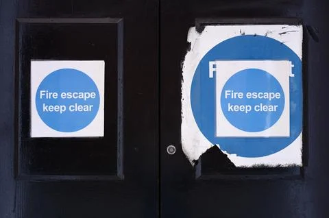 Fire exit keep clear sign on construction building site door Stock Photos