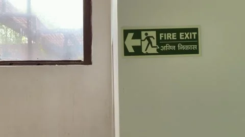 Fire Exit Sign board point the way , Green arrow with text Fire Exit. sign Stock Footage 288880783