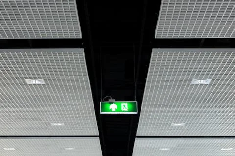 Fire exit sign on ceiling with light Stock Photos