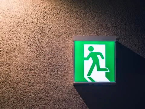 Fire Exit Sign Light box on wall Building Safety signage Stock Photos