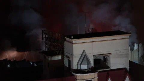 The fire exploded, and the firefighters rushed to extinguish the fire. Stock Footage 221789740