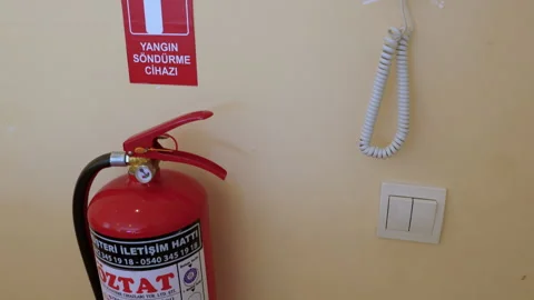 Fire extinguisher and intercom system on an office wall Vidéo 347057271