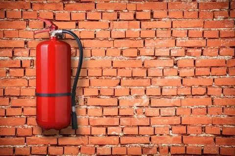 Fire extinguisher on brick wall 库存照片