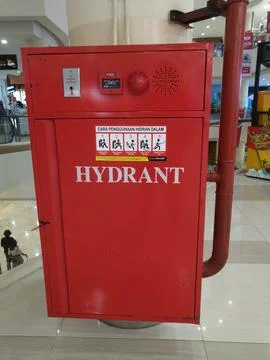 Fire extinguisher in building Stock Photos