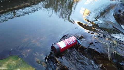 Fire extinguisher floating in river pollution concept 4K Stock Footage 330270295