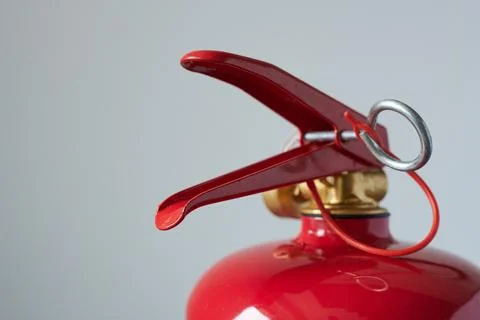Fire extinguisher on a gray background, close-up, macro Stock Photos