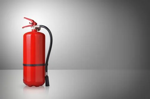 Fire extinguisher on gray background Stock Photos