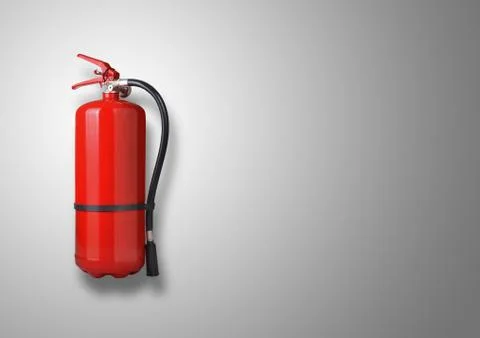 Fire extinguisher on gray background Stock Photos