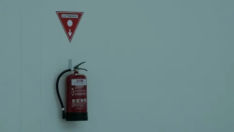 Fire extinguisher hanging in the wall Stock Footage 122602976