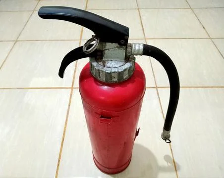 The fire extinguisher is red Stock Photos