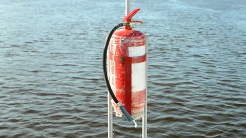 Fire extinguisher, red security object on blue water, environment diversity. Video stock 90905802