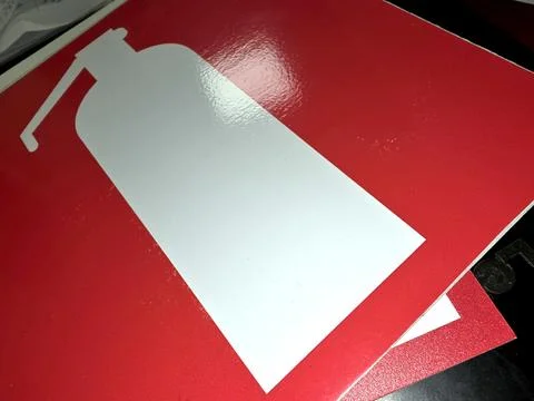 A fire extinguisher sign is displayed on a flat surface to provide essential  Stock Photos
