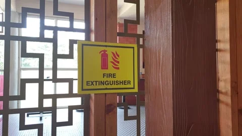 Fire extinguisher sign on wall pointing Stock Footage 295319290