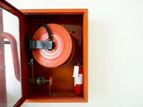 Fire extinguisher with various types of fire extinguishers Located In the whi Stock Photos