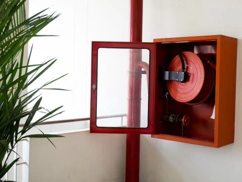 Fire extinguisher with various types of fire extinguishers Located In the whi Stock Photos