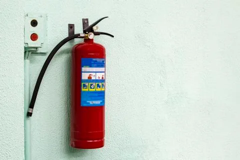 Fire Extinguisher on wall Stock Photos