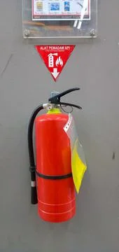 Fire extinguisher on the wall Stock Photos
