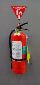 Fire extinguisher on the wall Stock Photos