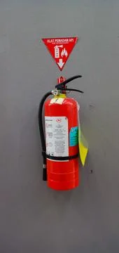 Fire extinguisher on the wall Stock Photos