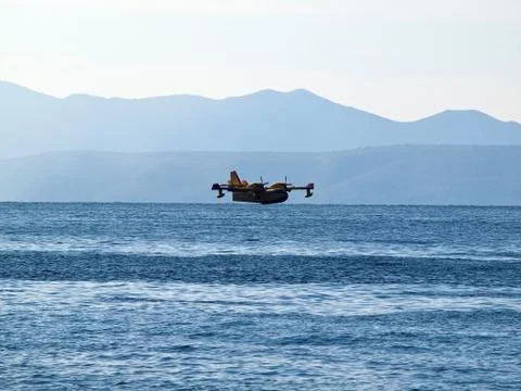 Fire figher airplane preparing to land at sea Stock Photos