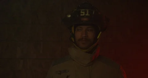 Fire Fighter center frame looking around dark smoke filled room Stock Footage 108818896