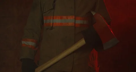 Fire Fighter holding axe at waist level - slowly zooming in Stock Footage