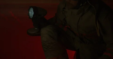 Fire fighter kneeling down with axe in hand - slow tilt down shot Stock Footage 107130824