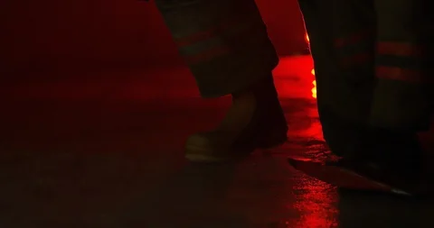 Fire Fighter kneeling on ground - close up on feet Stock Footage 108821704