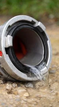 Fire fighter Pipe with water comming out Stock Photos