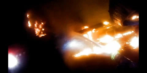 Fire Fighter putting out burning house Video stock 290473203
