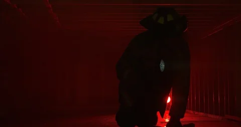 Fire Fighter rescuer shining light as he crawls searching for missing people Stock Footage 107130709