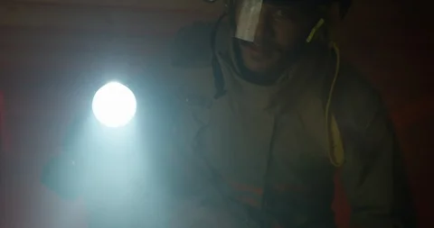 Fire Fighter shines flashlight towards the camera Stock Footage 108821327