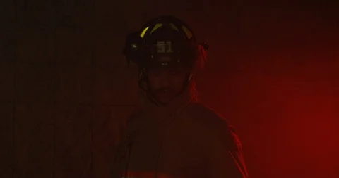 Fire Fighter walks into smoke filled room and looks around Stock Footage 108819760