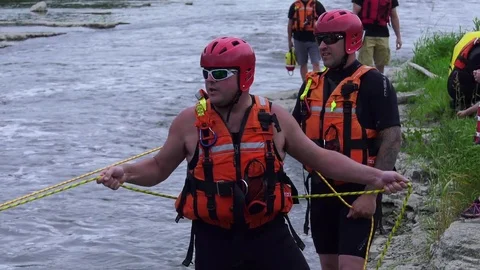 Fire fighter water rescue unit holding rope 4k Stock Footage 78080929