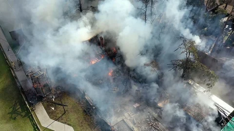 Fire fighter in white hat with smoke filter sprays water &amp; extinguish the fire Stock Footage 113112322